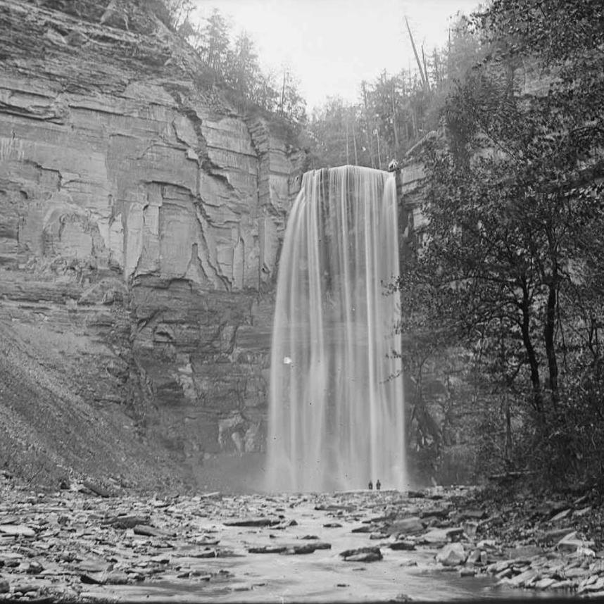 Historical black and white photo of a large waterfall
